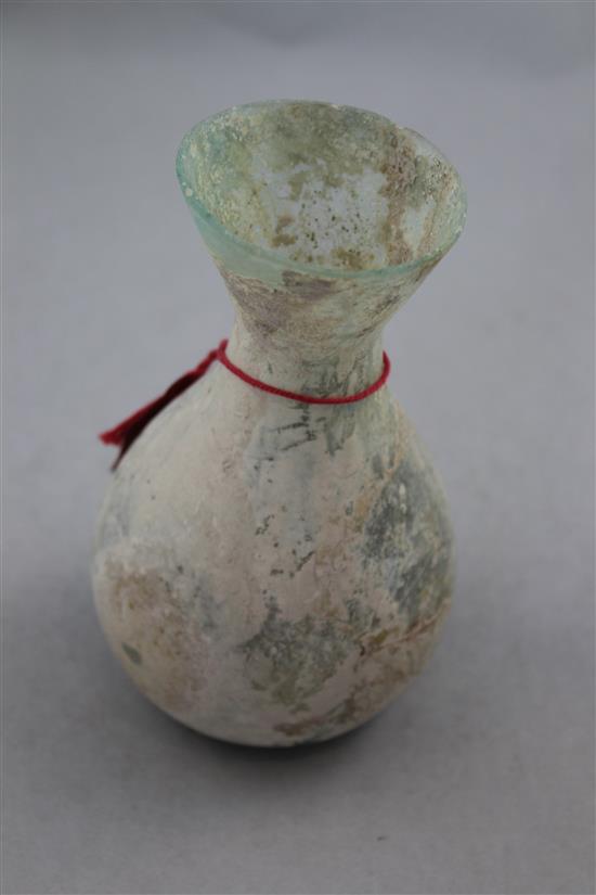 An Islamic glass bottle shaped vessel, c.400 AD, 15cm, cracks